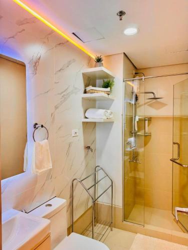 a bathroom with a shower and a sink at RJ Elite Escape 2BR Condo w balcony near SM Iloilo in Iloilo City