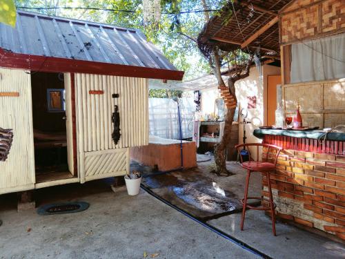a small chicken house with a table and a chair at SECLUDED GLAMPING YOGA SAMADHI fan 2 kubos 8 pax in Rimus
