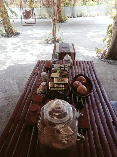 a wooden bench with food on top of it at SECLUDED GLAMPING YOGA SAMADHI fan 2 kubos 8 pax in Rimus
