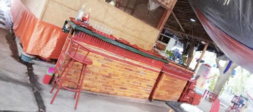 a red ladder is standing in front of a brick building at SECLUDED GLAMPING YOGA SAMADHI fan 2 kubos 8 pax in Rimus
