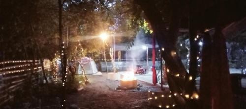 a lit up street at night with a street light at SECLUDED GLAMPING YOGA SAMADHI fan 2 kubos 8 pax in Rimus