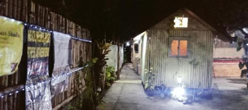 a building with a light on the side of it at night at SECLUDED GLAMPING YOGA SAMADHI fan 2 kubos 8 pax in Rimus