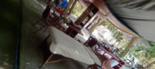 a group of chairs sitting on top of a porch at SECLUDED GLAMPING YOGA SAMADHI fan 2 kubos 8 pax in Rimus