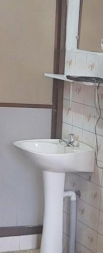 a bathroom with a white sink and a mirror at BB&B Hostel in La Paz