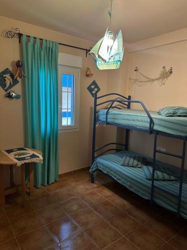 a room with two bunk beds and a window at Beach Apartment in Huelva