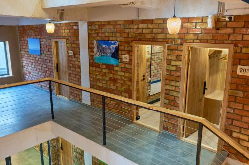 a room with a brick wall and a staircase at Pristine Hotel in Bishkek