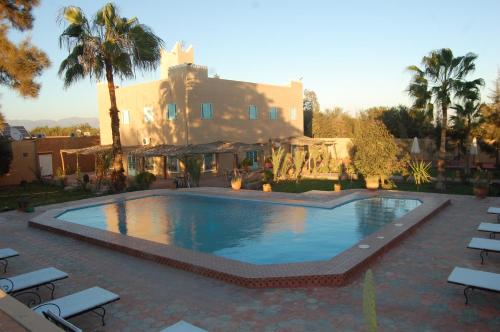 a large swimming pool in front of a building at Gite Souss in Oulad Teima