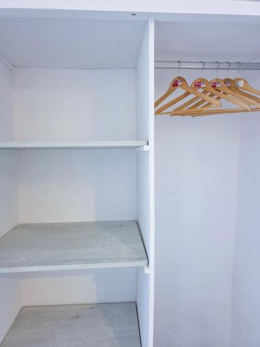a white walk in closet with white shelves at Calypso Heaven in Santorini
