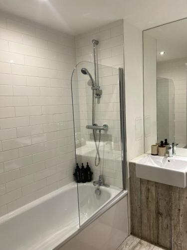 a bathroom with a shower and a sink at Manchester Central - Modern Apartment - Free Parking in Manchester