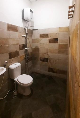 a bathroom with a toilet and a sink at Kosasih 1919 A Dutch-Retro House in Banyuwangi