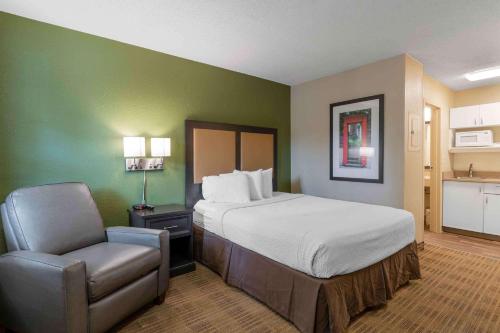 a hotel room with a bed and a chair at Extended Stay America Suites - Louisville - Dutchman in Louisville