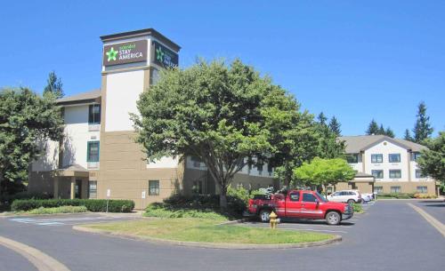 a red truck parked in front of a building at Extended Stay America Suites - Portland - Vancouver in Evergreen