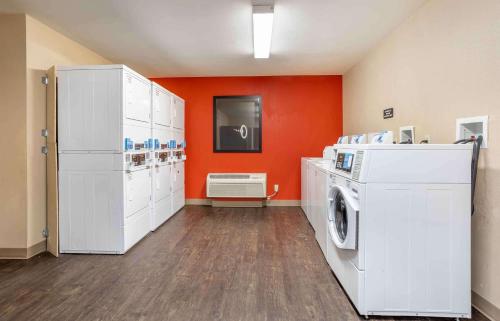 a laundry room with white appliances and an orange wall at Extended Stay America Suites - Somerset - Franklin in Somerset