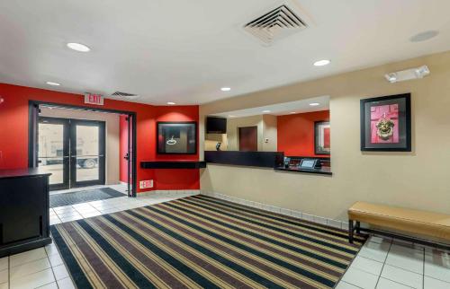 a lobby with red walls and a waiting room at Extended Stay America Suites - South Bend - Mishawaka - North in South Bend
