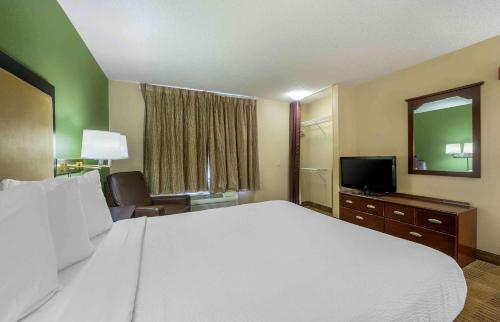 a hotel room with a large bed and a television at Extended Stay America Suites - South Bend - Mishawaka - North in South Bend