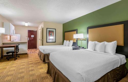a hotel room with two beds and a desk at Extended Stay America Suites - South Bend - Mishawaka - North in South Bend