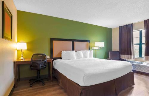 a bedroom with a bed and a desk and a chair at Extended Stay America Select Suites - Austin - Northwest - Research Park in Austin