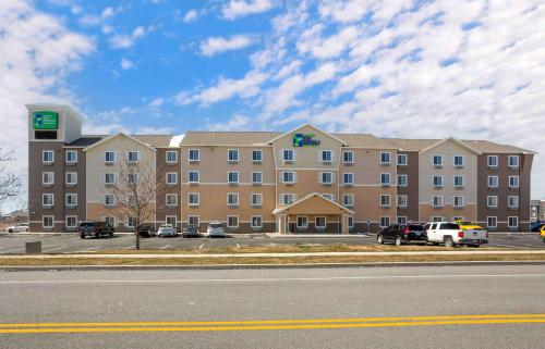 a large building with cars parked in a parking lot at Extended Stay America Select Suites - Provo - American Fork in Lehi