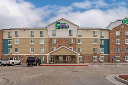 a hotel with a car parked in a parking lot at Extended Stay America Select Suites - Salt Lake City - West Valley City in West Valley City