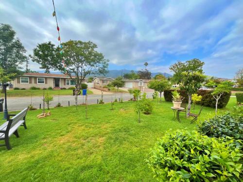 a park with a bench and a kite in the grass at Cozy Beautiful Private Home in Prime Location in Glendora