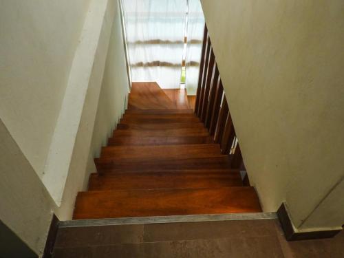a staircase in a building with wooden floors and a window at Casa moderna con Piscina, Iquitos in Iquitos