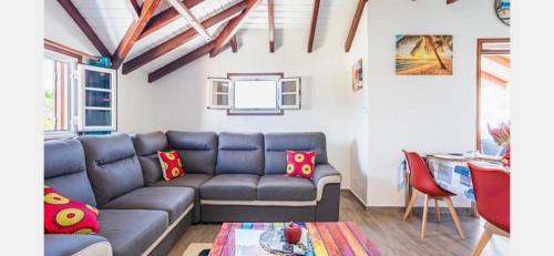 a living room with a couch and a table at Villa Caraibe in Petit-Canal