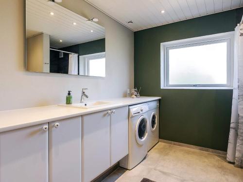 a laundry room with a washing machine and a window at 4 star holiday home in Asperup in Asperup