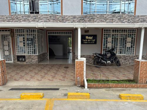 a motorcycle parked in the entrance to a building at Hotel Valle del Café - Habitación 8 Grupo 2 Camas in Sevilla