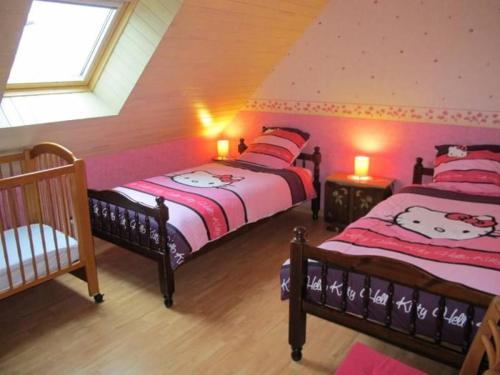 a bedroom with two beds with hello kitty pillows at Gîte calme proche plage et commerces au Croisic avec jardin, Wi-Fi, 4 chambres - FR-1-306-1308 in Le Croisic