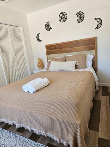 a bedroom with a large bed with black and white pillows at Newly Renovated Modern Studio in Oviedo
