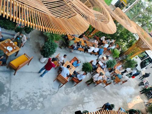 a group of people sitting at tables in a restaurant at Happy Bear Hostel Phu Quoc in Phu Quoc