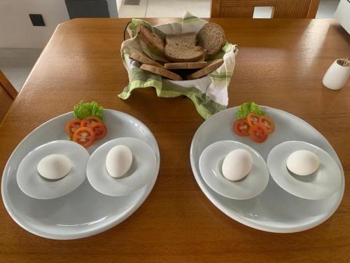 two white plates with eggs and tomatoes on a table at Madiha Venus in Matara