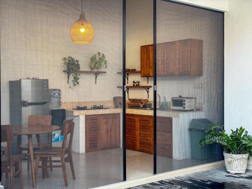 a kitchen with a table and a dining room at MoHana Villa - A Minimal Canggu Oasis in Canggu