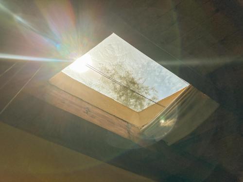 a book on a table with the sun shining at Waterside Loft -Rustic & Lux Tunis Artisan Village in Tunis