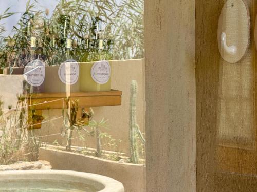 a bathroom with a sink and a window with plants at Waterside Loft -Rustic & Lux Tunis Artisan Village in Tunis