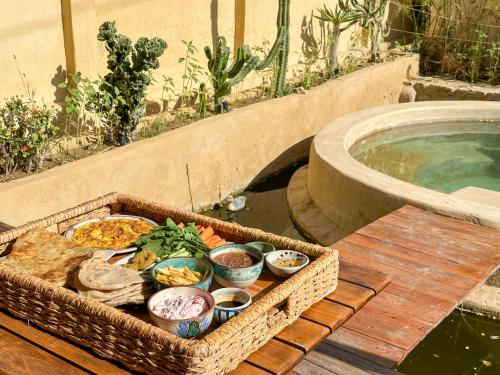 a basket of food sitting on a table next to a tub at Waterside Loft -Rustic & Lux Tunis Artisan Village in Tunis