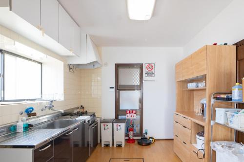 a large kitchen with a sink and a window at ocean blue mint海まで３分! 南房総最南端の１棟まるごと貸別荘 in Hongō