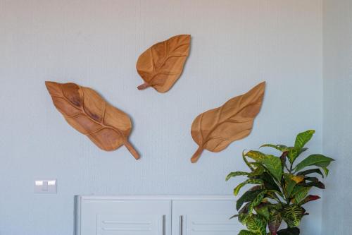 a group of wooden leaves hanging on a wall at Oceanview 3BR Villa with 3 Shared Pools and Beachfront Resort Access in Ocotal