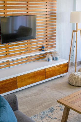 a living room with a large flat screen tv on a wall at Oceanview 3BR Villa with 3 Shared Pools and Beachfront Resort Access in Ocotal