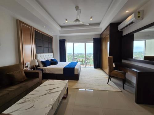 a hotel room with a bed and a couch at Luxury Sea View Apartments in Negombo