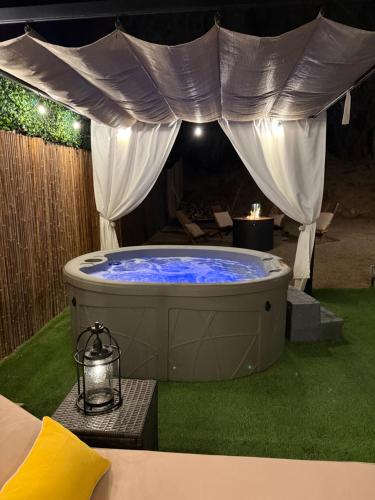a hot tub in a yard with a tent at Casita Needles with Jacuzzi, Firepit, Boat Parking in Needles