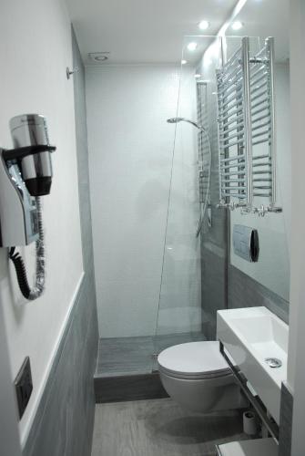 a bathroom with a toilet and a shower and a sink at LHP Suite Rapallo in Rapallo
