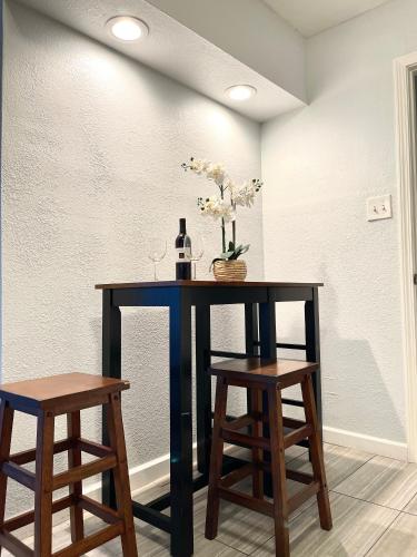 a table with two stools and a bottle of wine at Lovely Home 30MIN to Berkeley, SF, Napa in Pinole
