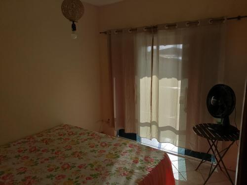 a bedroom with a bed and a window at Casa Refúgio da Prainha in Arraial do Cabo