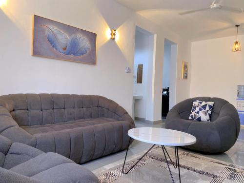 a living room with a couch and a table at NishHomes in Mombasa