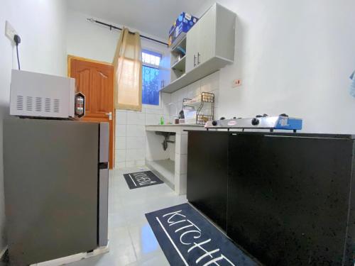 a kitchen with a black counter top in a room at NishHomes in Mombasa