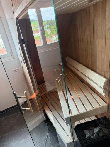 a room with a bunk bed and a glass wall at Hotel-Restaurant Kostbar in Engen