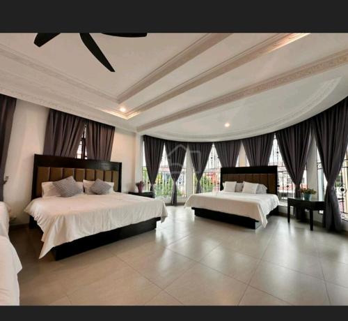 a large bedroom with two beds and windows at EDS Senior Citizen Care Centre in Cheras
