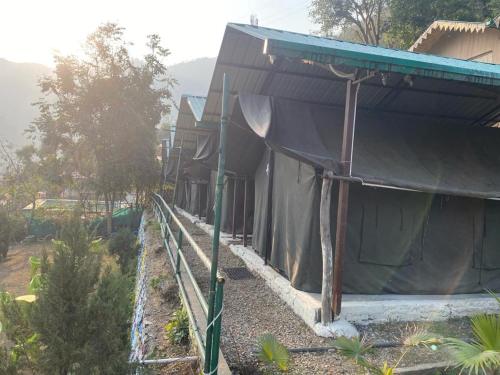 a building with a tent next to a garden at Cradle of Life in Shivpuri