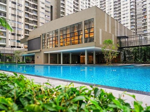 a large building with a large blue swimming pool at Nilai-YouthCity-Uitm-Gembox-Lovely Stay-2r2b in Nilai